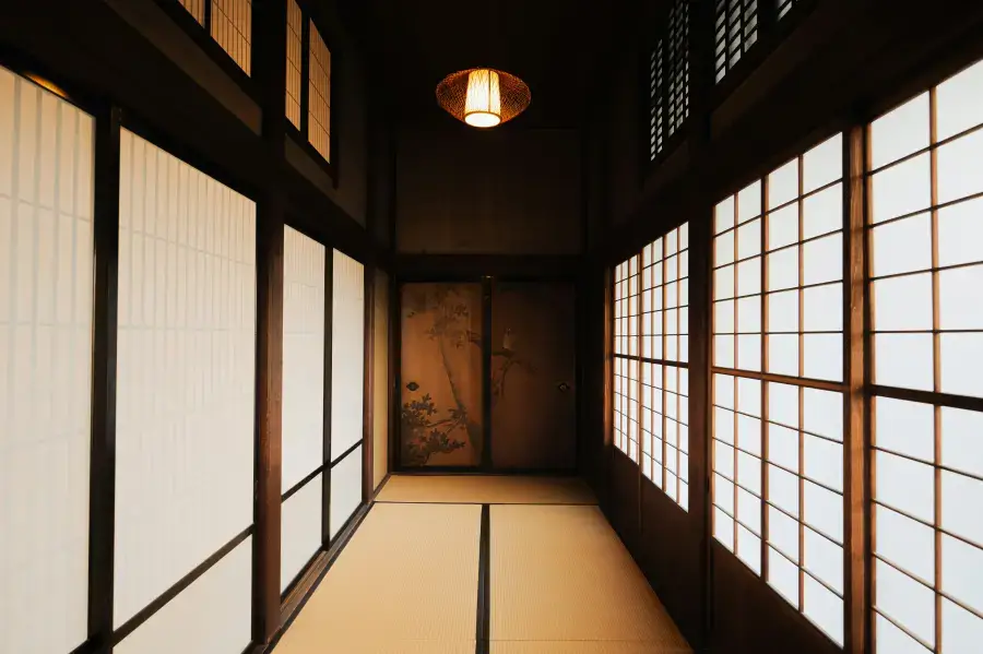 Traditional Japanese tatami corridor with shoji screens — shoes must be removed before entering tatami rooms