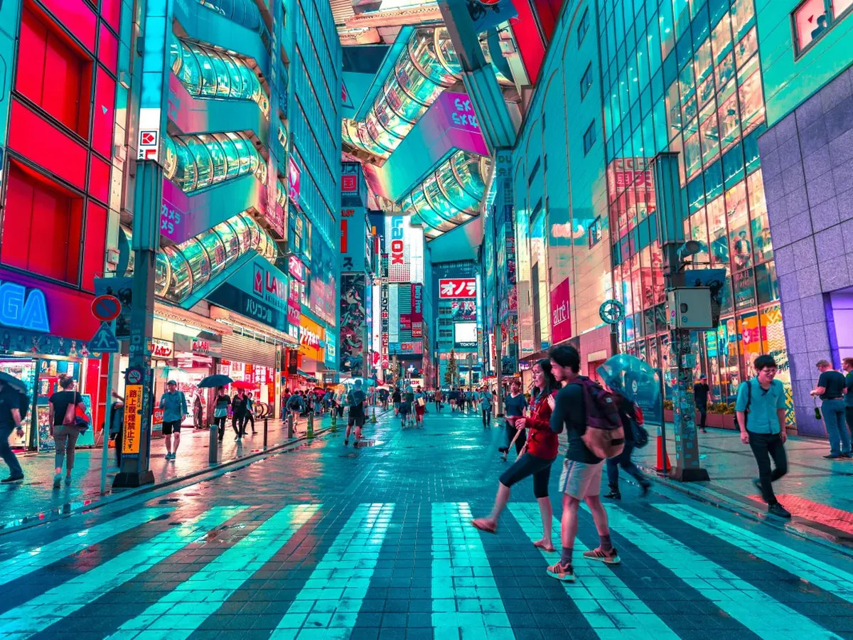 Neon-lit street in Tokyo at night with crowds of people — a vivid reminder of why careful planning matters for a luxury trip to Japan