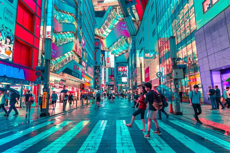 Neon-lit street in Tokyo at night with crowds of people — a vivid reminder of why careful planning matters for a luxury trip to Japan