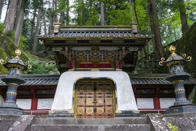 A gilded mausoleum gate amid the giant cedars of Nikko