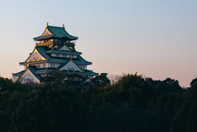 Osaka Castle illuminated at dusk