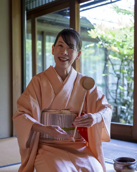 Hands whisking matcha during a private tea ceremony in Kyoto